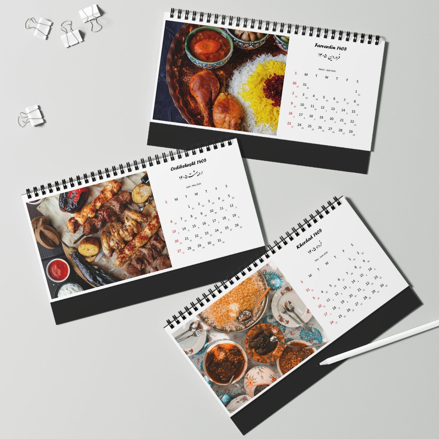 Three spiral-bound calendars with persian iranian food-themed images on a gray background